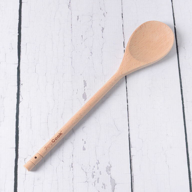 Premium Photo  Kitchen beige apron wooden spoon with spices pepper mill  wood kitchen utensils on a wooden background top view