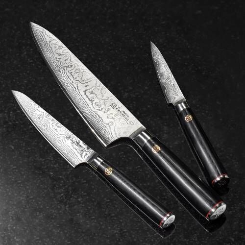 Image of ProCook Damascus 67 Knife Set lay flat on a kitchen worktop showing the wavy pattern of Damascus steel