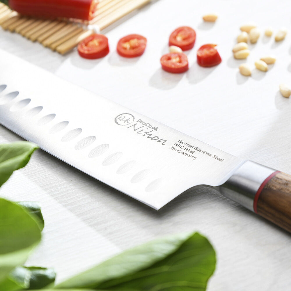 Close up image of ProCook Nihon X50 Santoku Knife showcasing the knife's scalloped edge