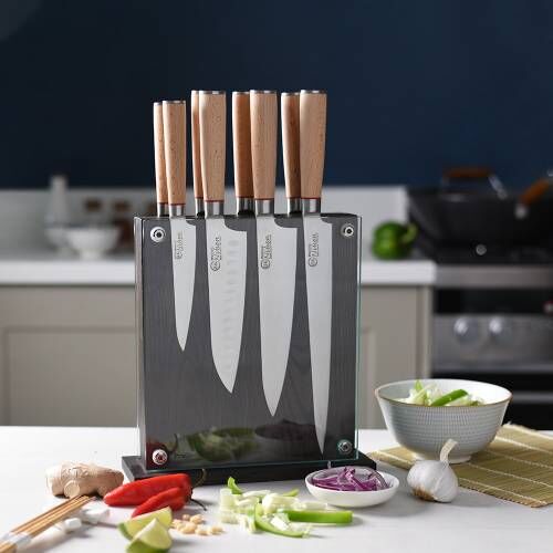 Image of ProCook Nihon X50 Knife Set stored in a magnetic glass block and surrounded by chopped vegetables